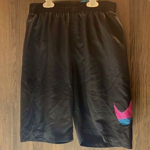 Nike swim trunks, youth XL, black shorts with pink, blue, and orange logo